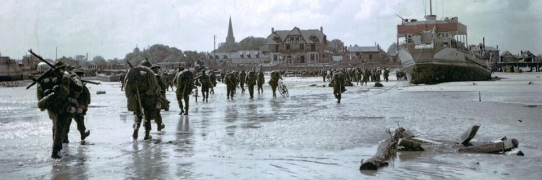 Canadian infantry landing at Juno Beach and marching toward Bernières-sur-Mer, 6 June 1944.