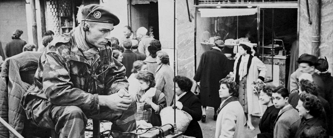 During the Battle of Algiers, a paratrooper of the 1st Foreign Parachute Regiment (1st REP) keeps watch over Clauzel market, as the FLN-declared strike subsides and shops reopen, Algiers, 3 February 1957.